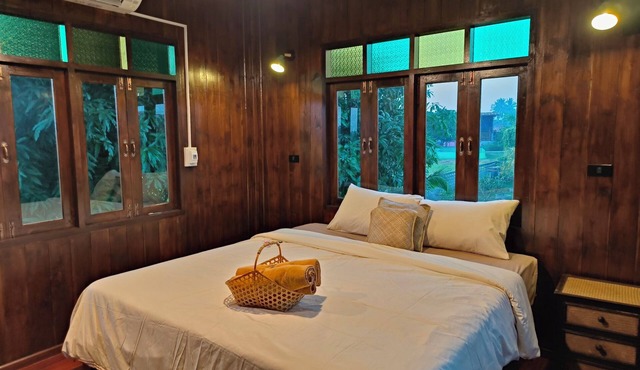 Charming Thai-style villa in lush greenery 10 mins from bus station near city.